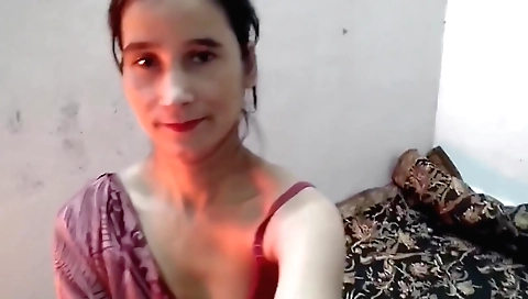 Solo indian female in white dress and bra in her bedroom