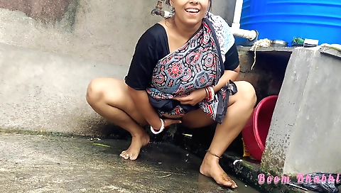 sexy indian brunette is on the grass taking care of her pussy