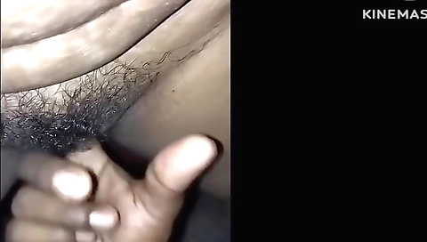 Indian girl in a black t-shirt is hairy on the bed